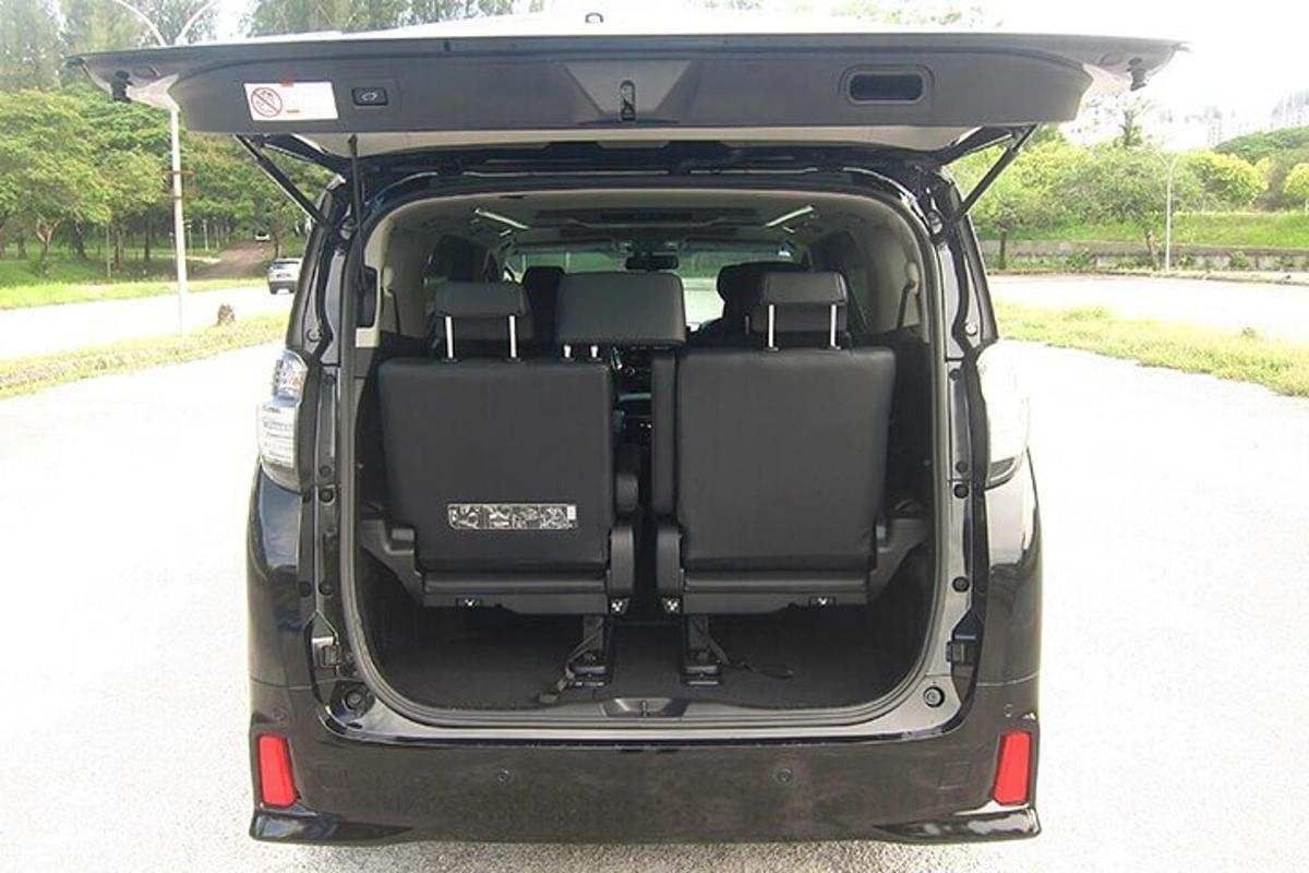a car with its trunk open on a road