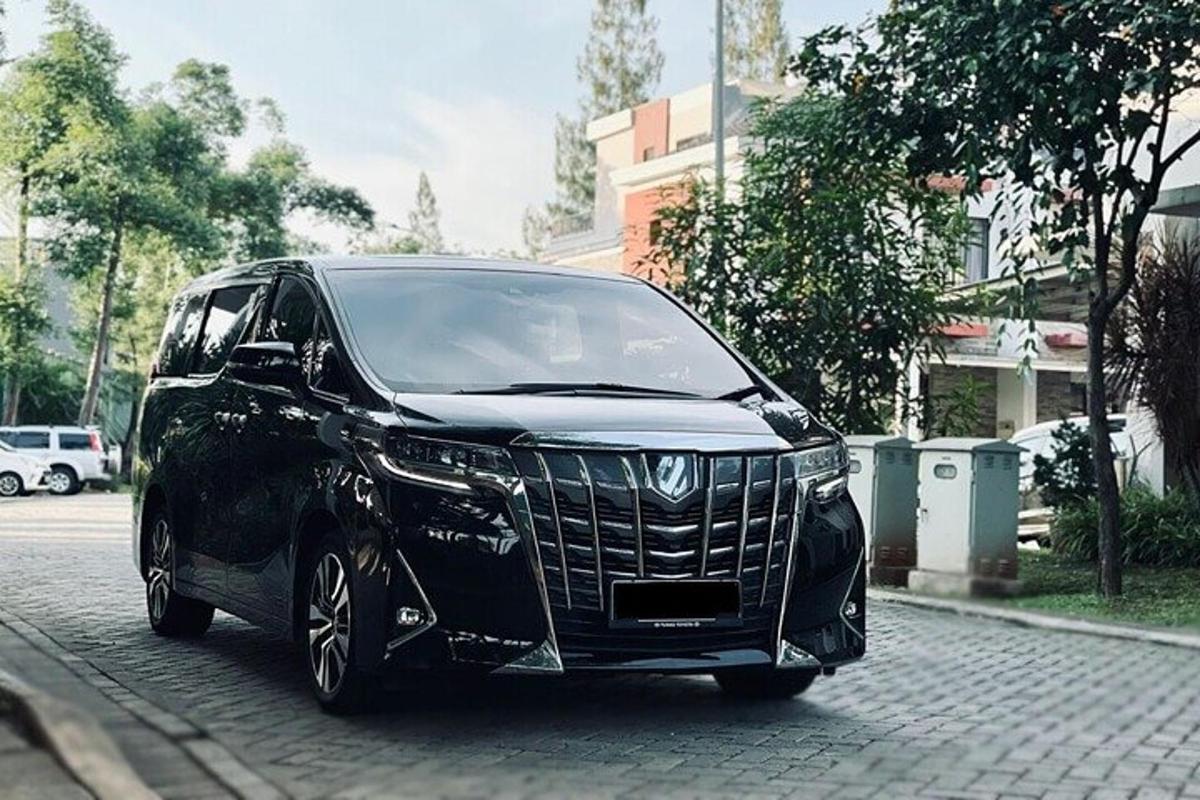 a black car is parked on a street