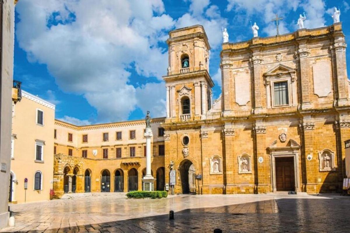 a large building with a clock tower in a courtyard