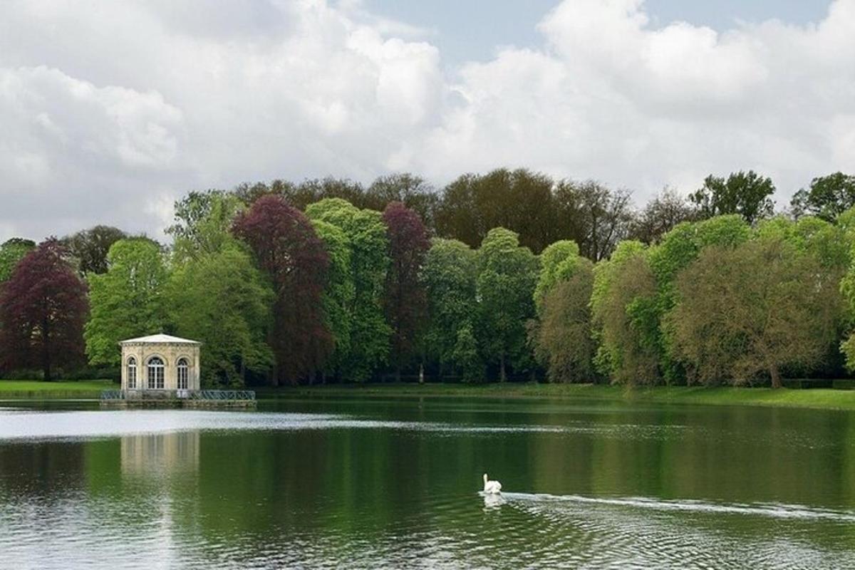 a duck in the middle of a lake with a building