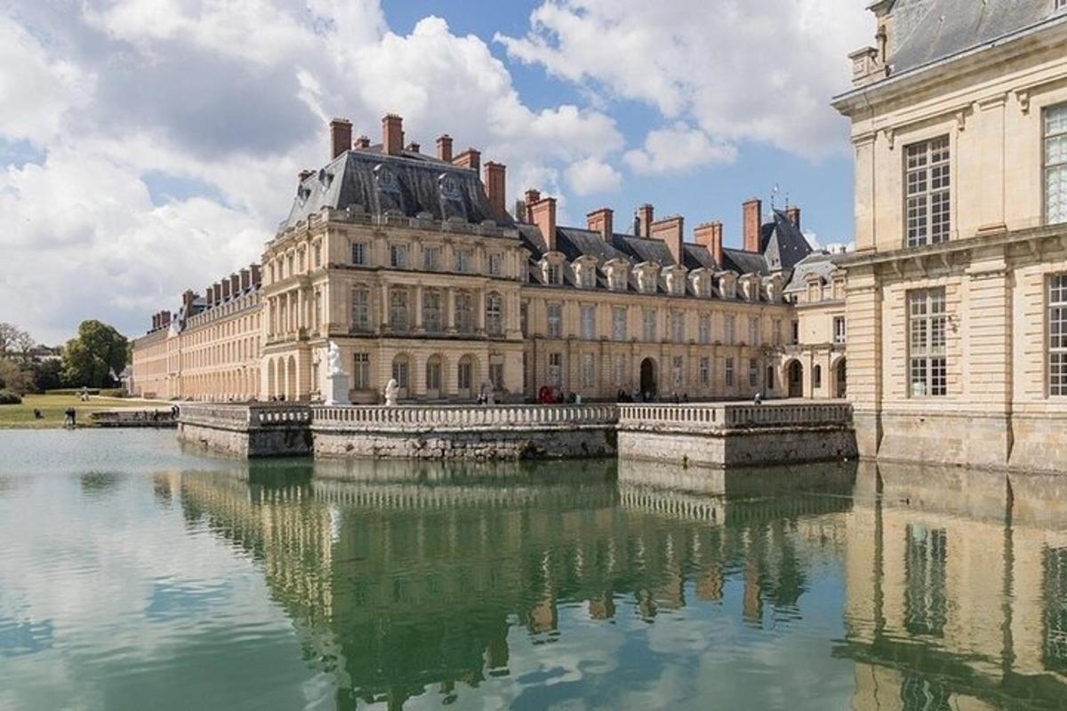 a large building with its reflection in the water