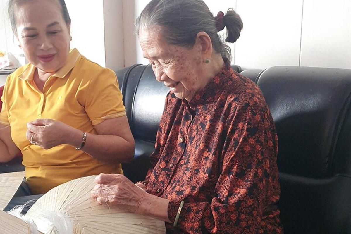 an older woman sitting next to a woman