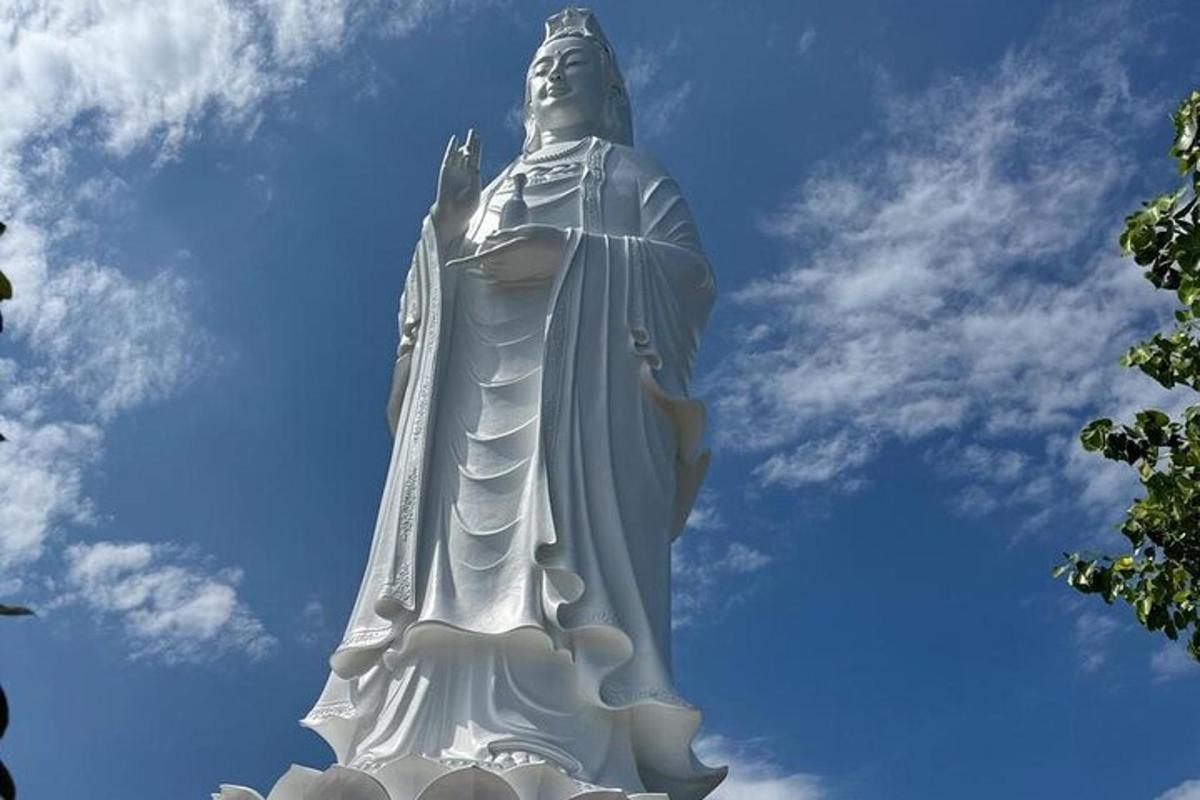 a large statue in front of a blue sky