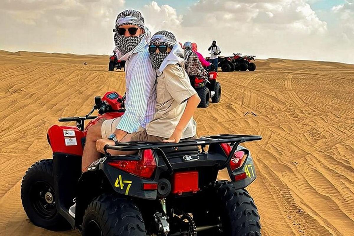 a group of people riding on atvs in the desert