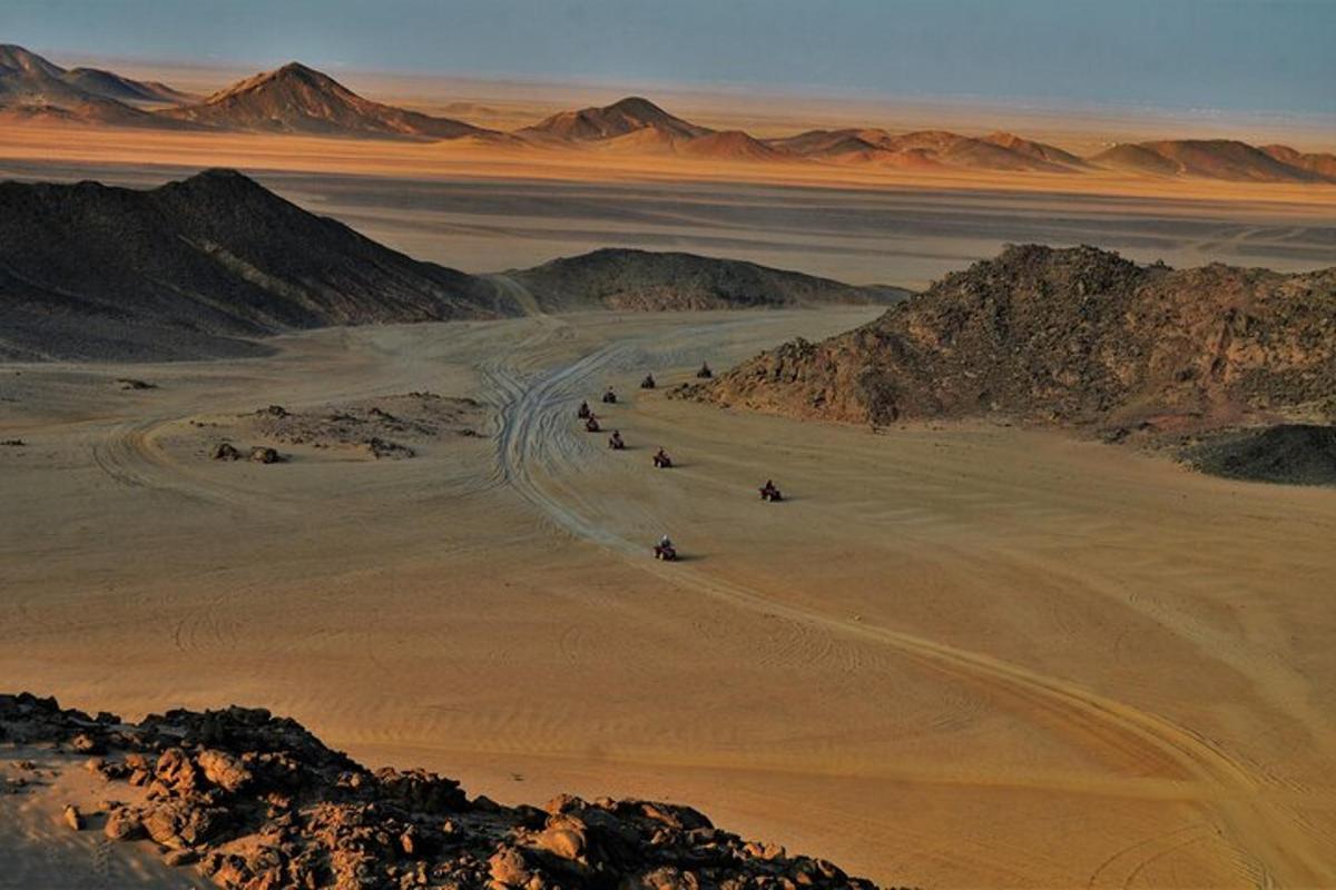 a group of people riding horses in the desert