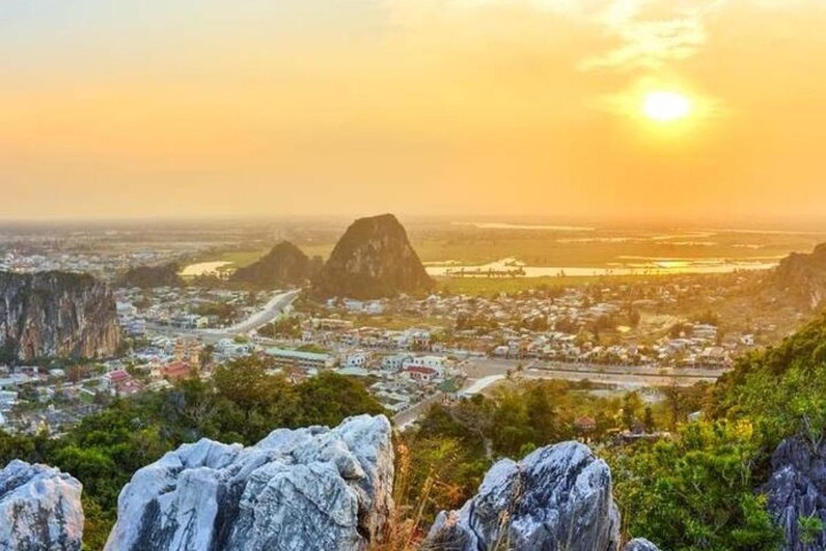 a view of a city from a mountain with rocks