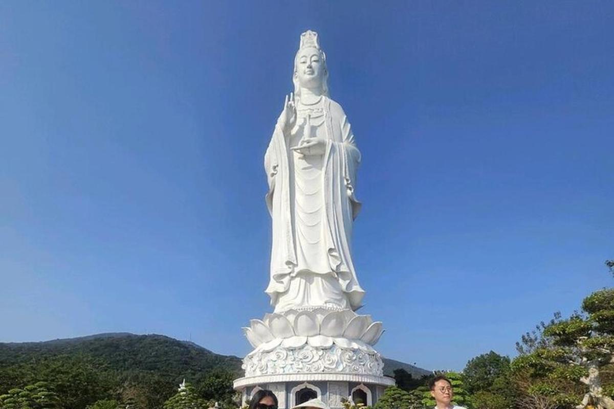 a man standing in front of a statue
