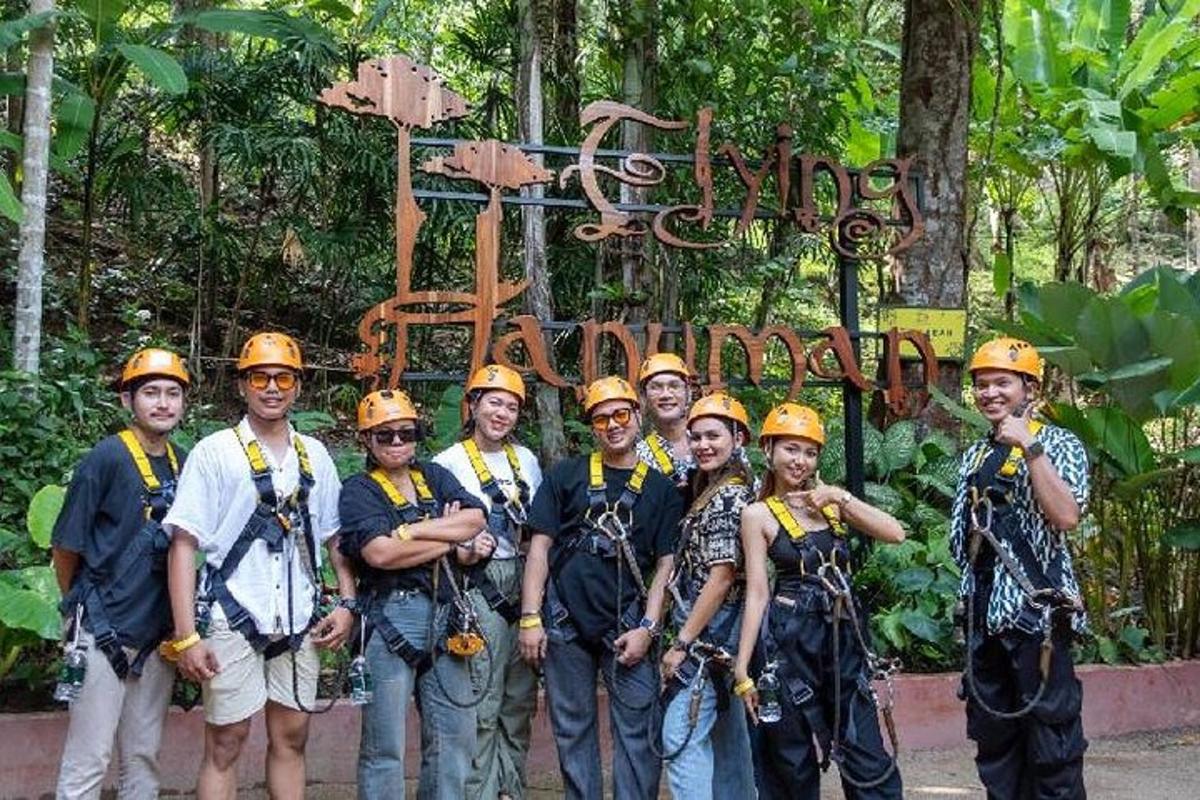 a group of people wearing hard hats standing in front of a sign