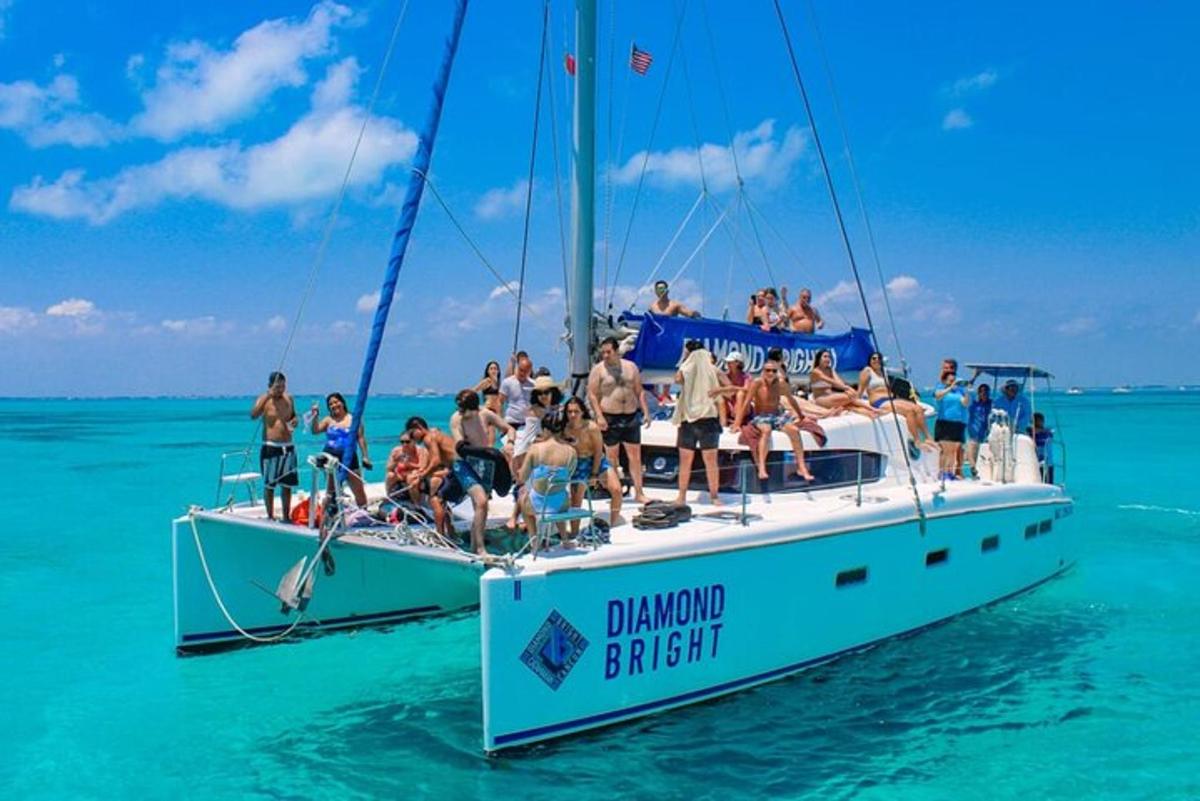 a group of people on a sailboat in the ocean
