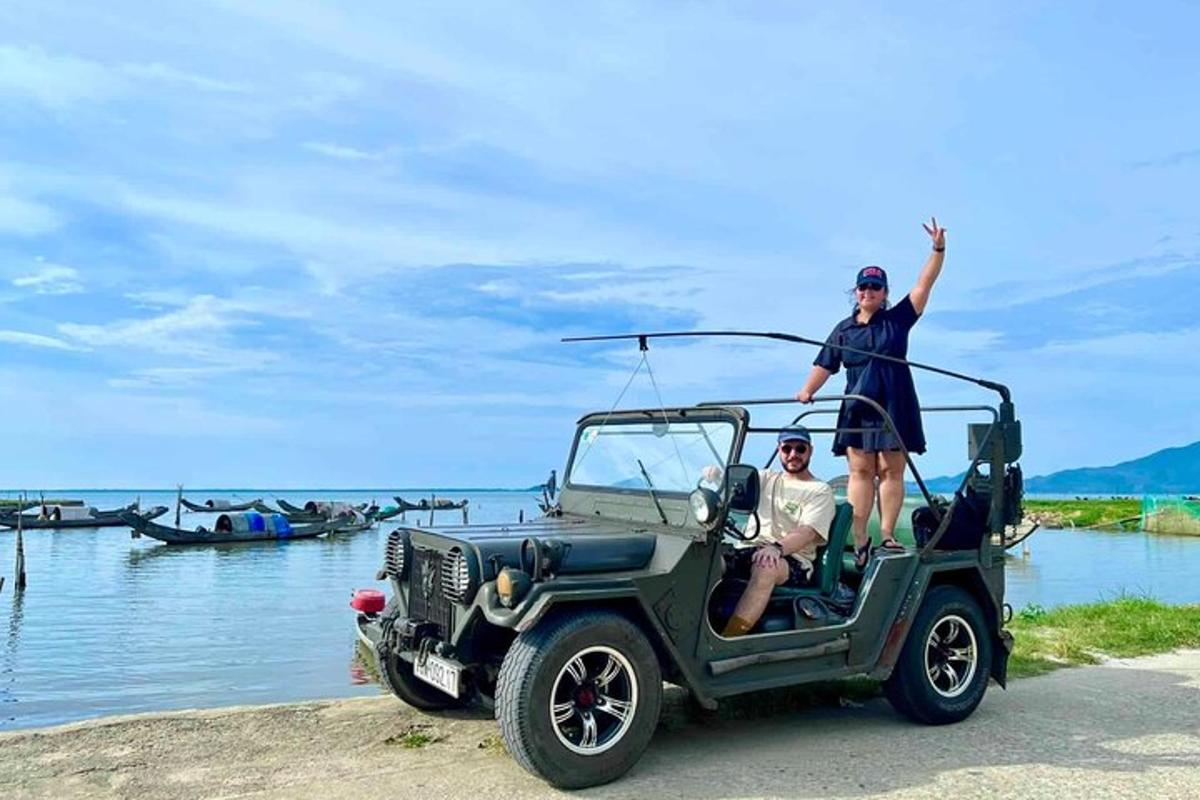 en mann og en kvinne som står på baksiden av en jeep