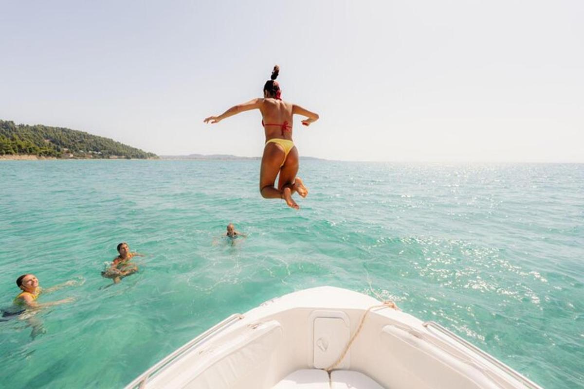 a woman jumping off of a boat in the water
