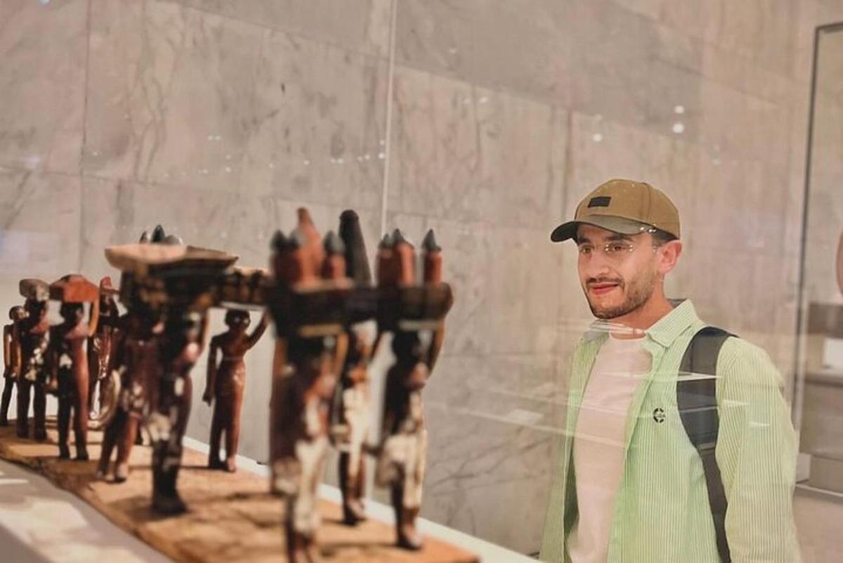a man in a hat standing next to a figurines
