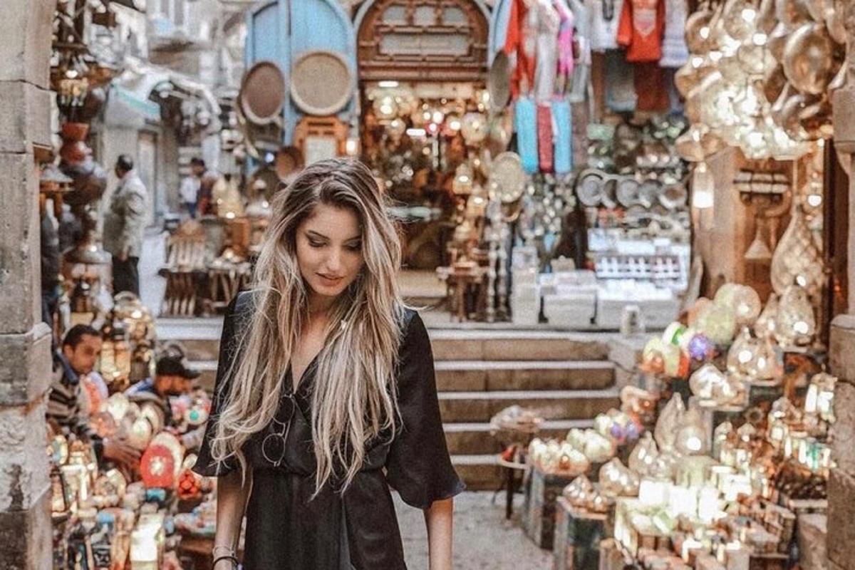 a woman walking through a shop in a market