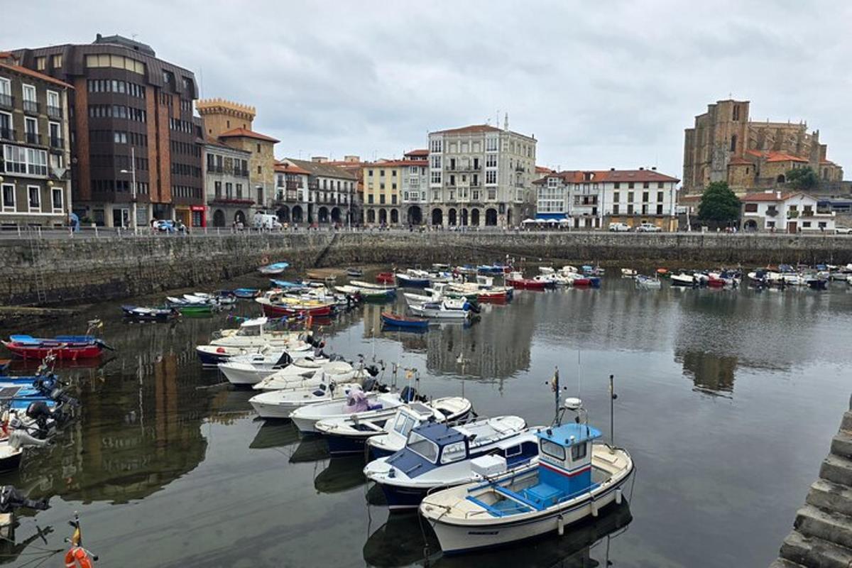 a group of boats docked in a river with buildings