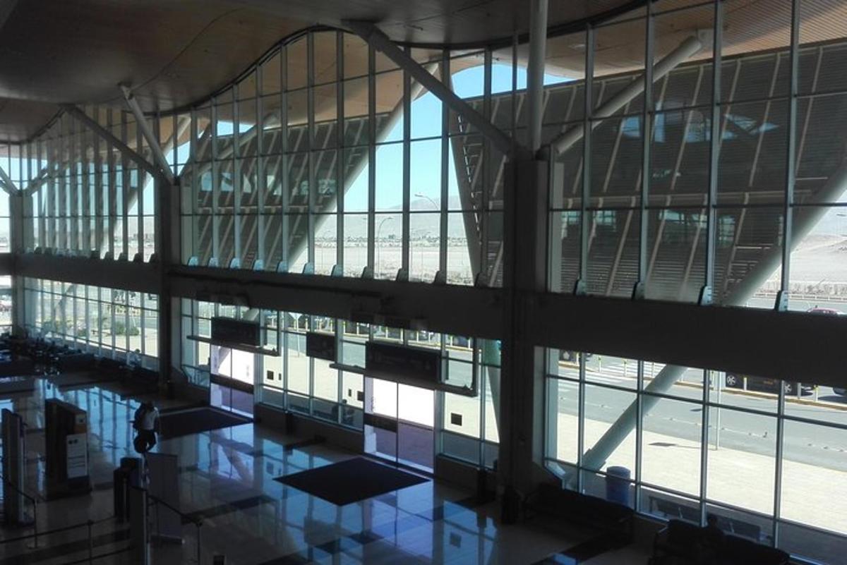 an airport terminal with a pool of water in a building