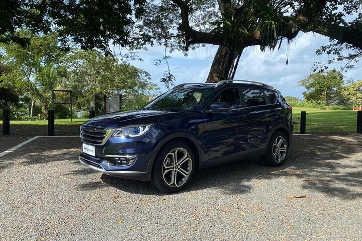 a blue car parked next to a basketball hoop
