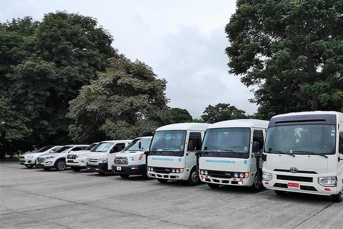 a row of white trucks parked in a parking lot