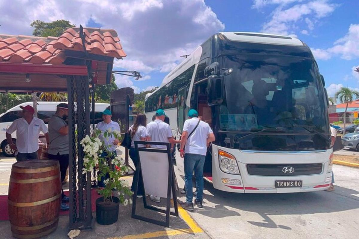 a group of people standing in front of a bus
