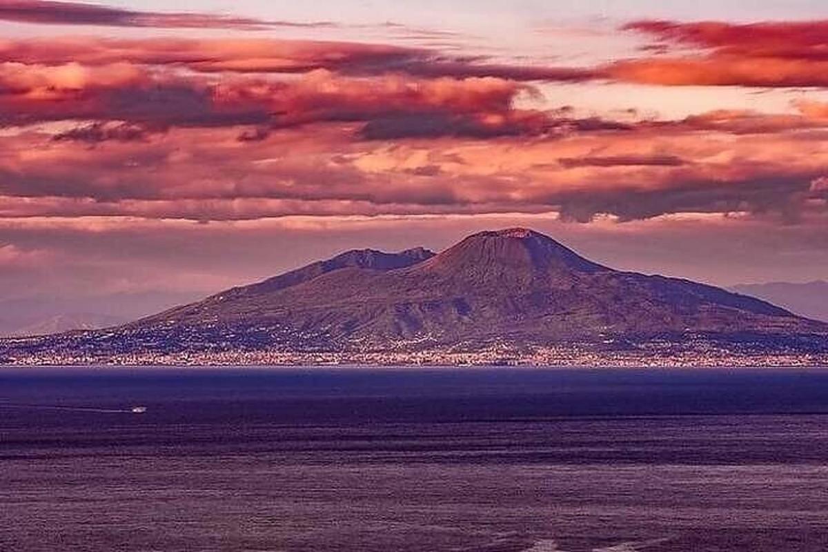 a mountain in the middle of a body of water