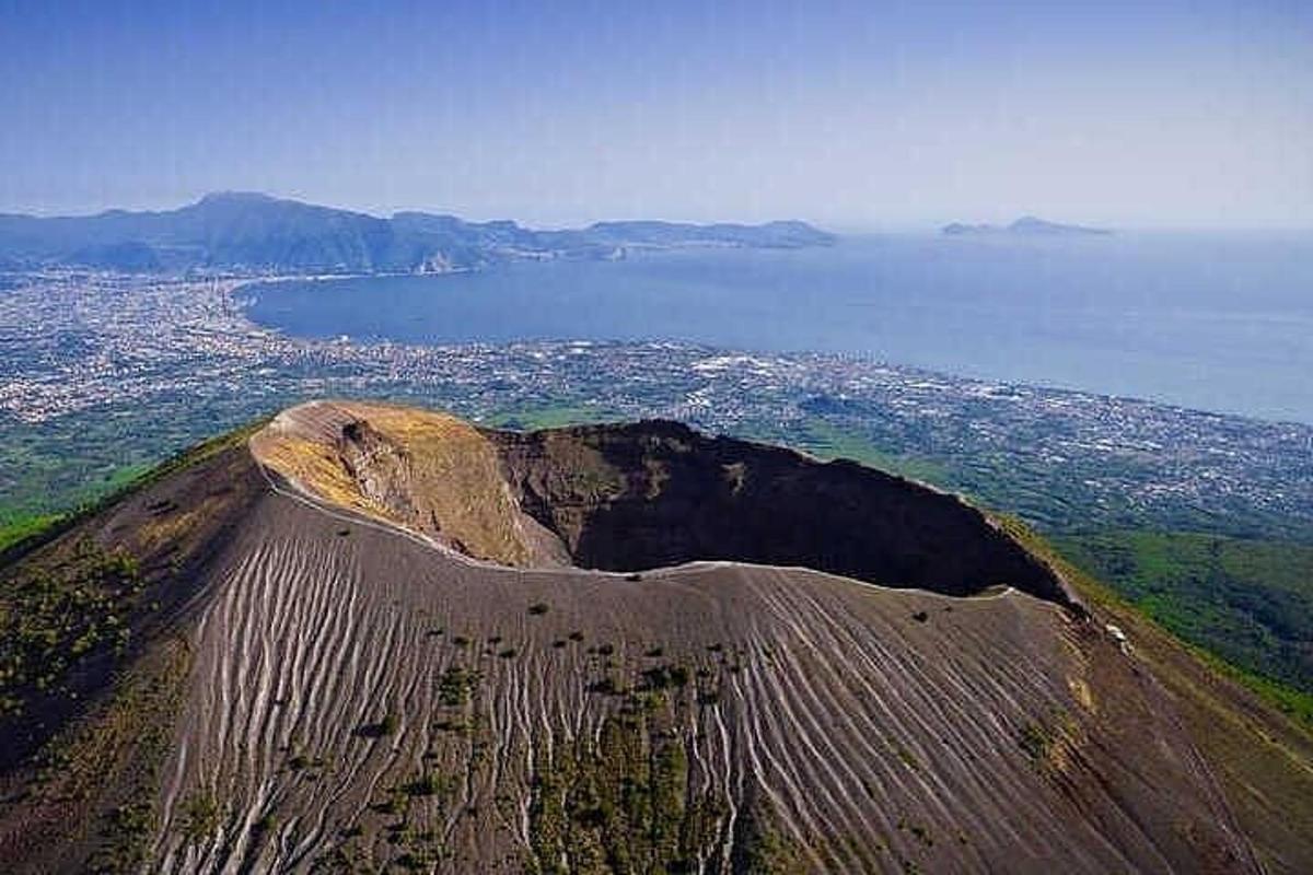 an aerial view of a mountain with the ocean