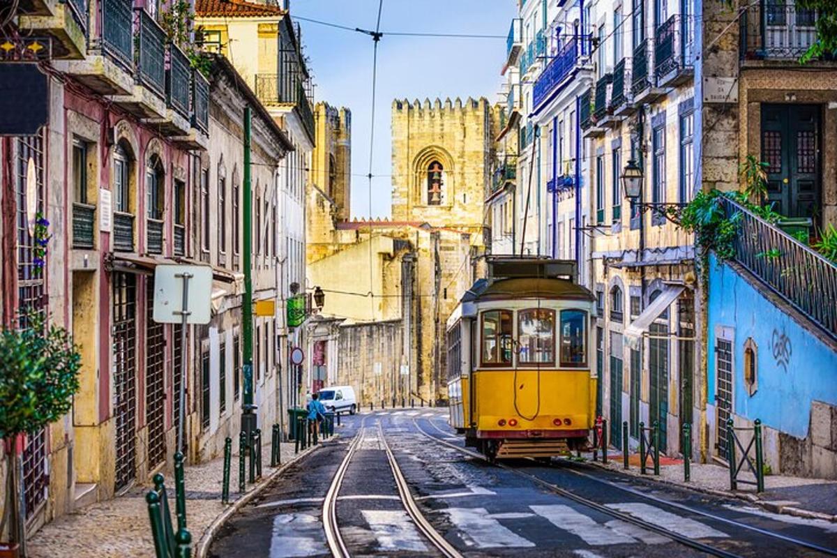 a yellow tram on a city street with buildings