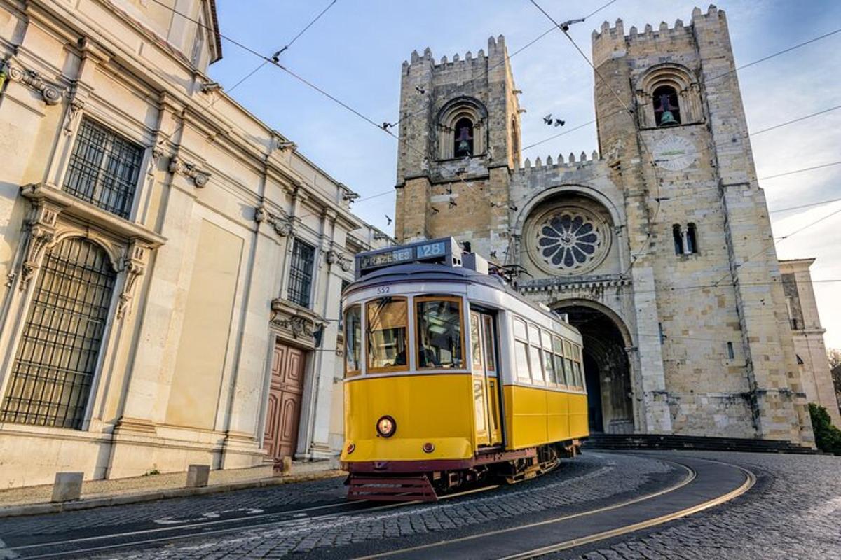 a yellow tram in front of a church
