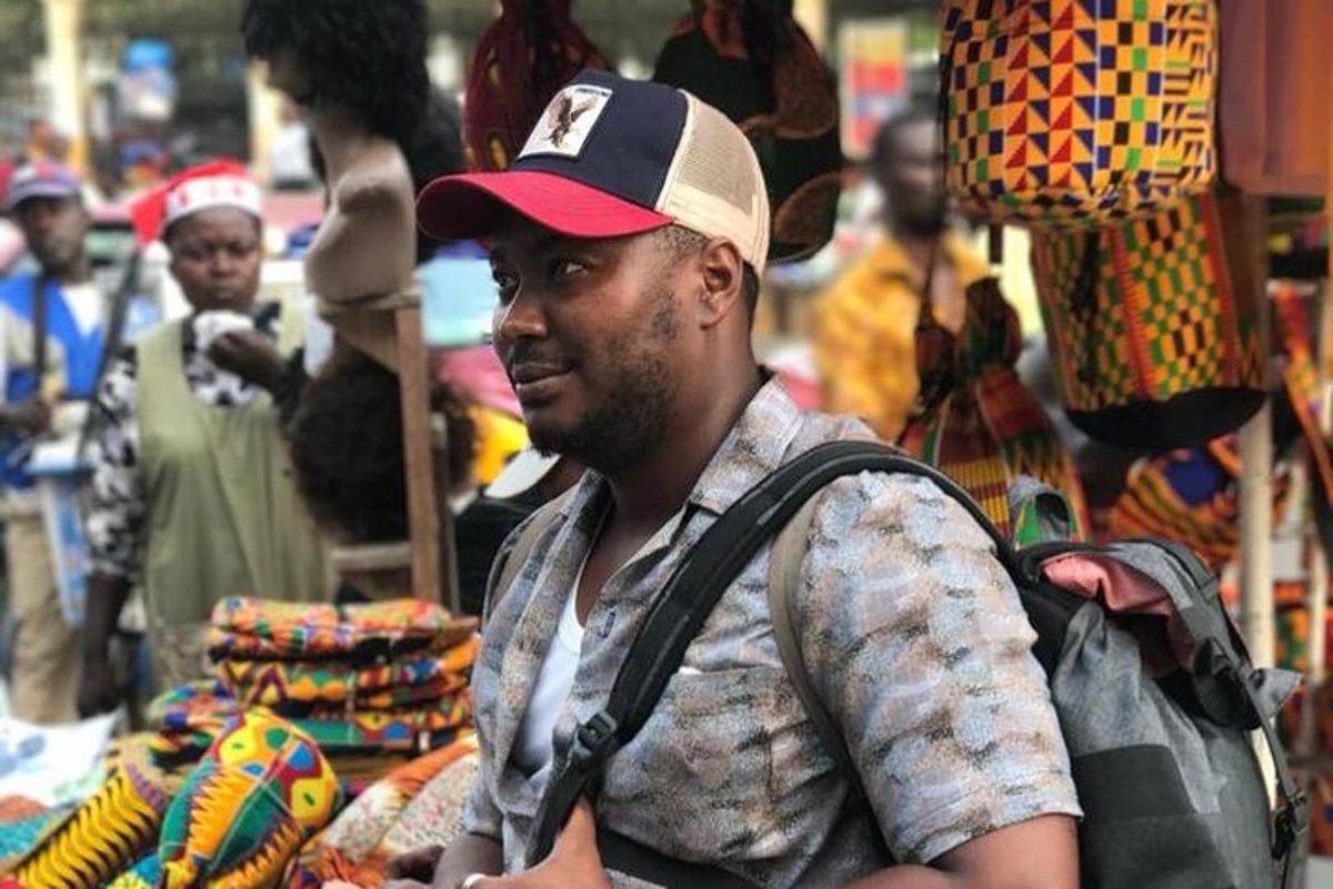 un uomo che indossa un cappello in piedi in un mercato