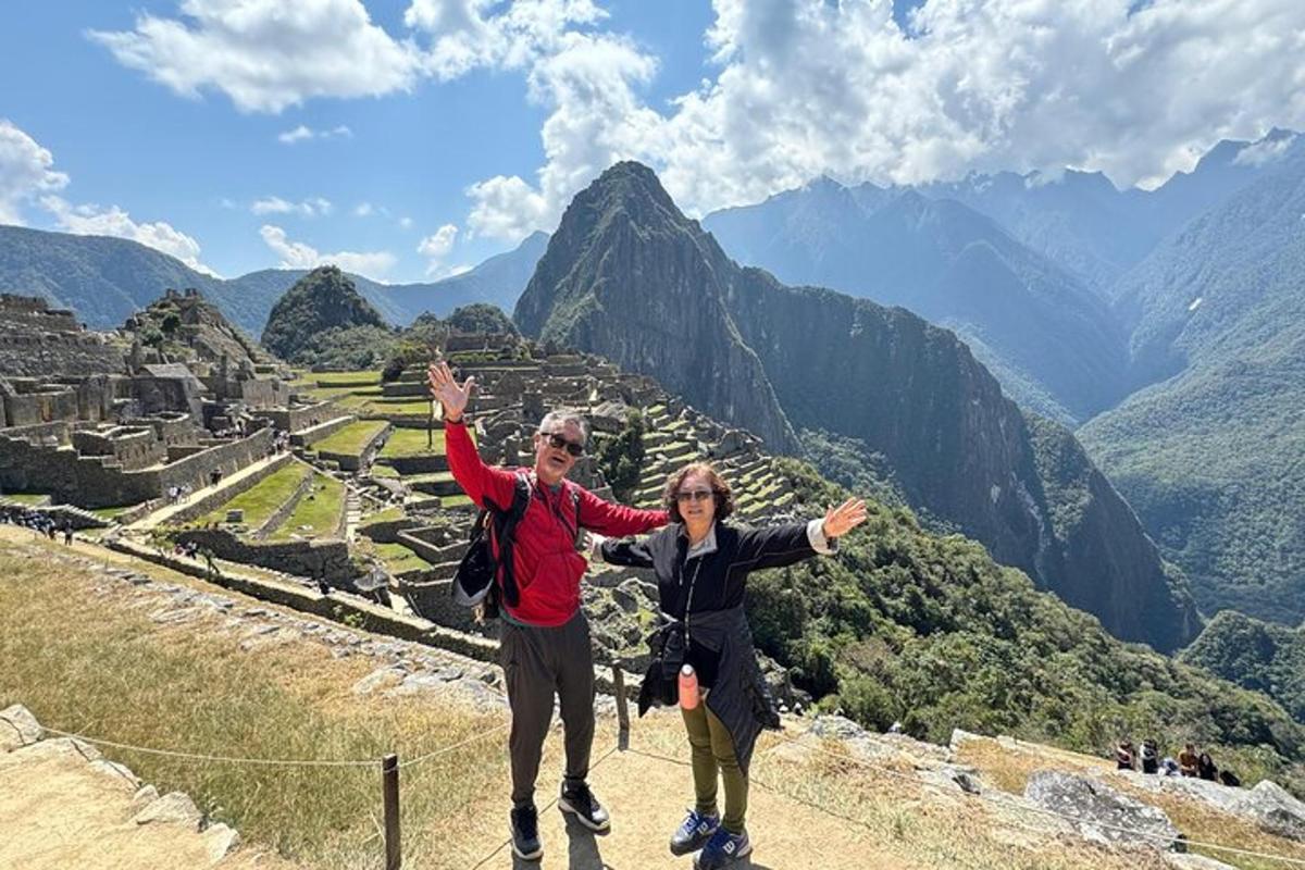 a man and a woman standing on top of a mountain