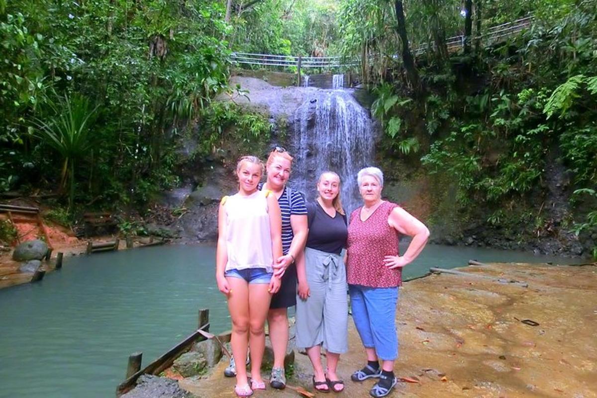 a group of people standing in front of a waterfall