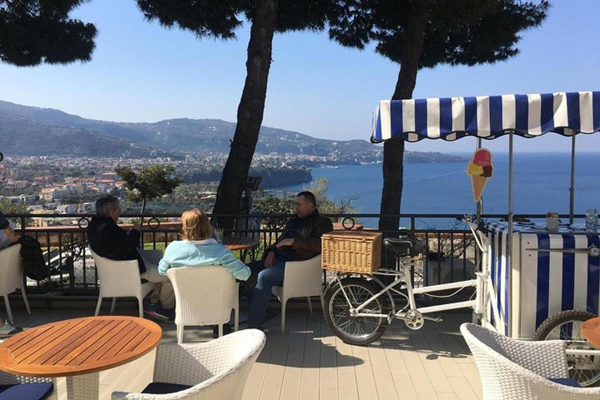 a group of people sitting at a table on a patio