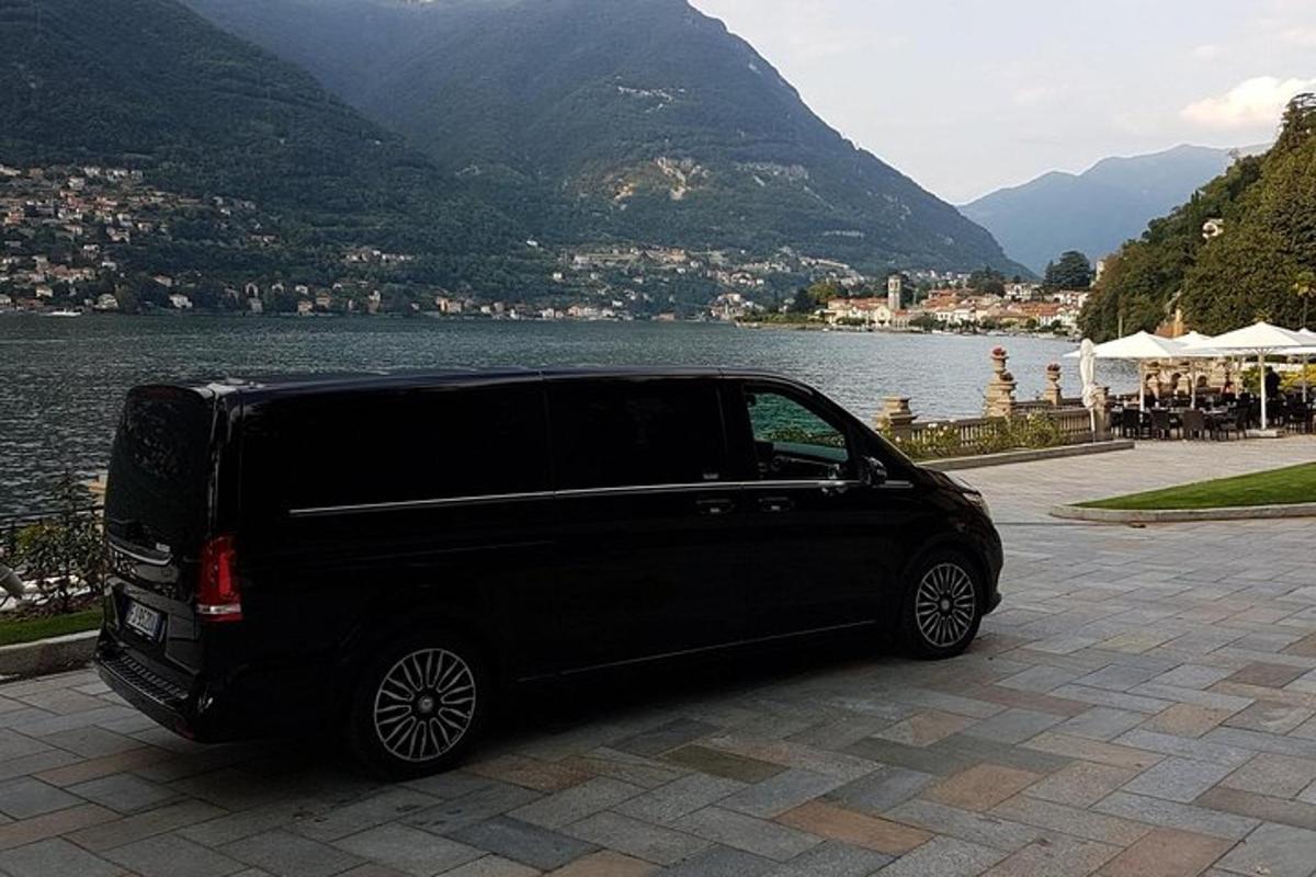 a black van parked next to a body of water