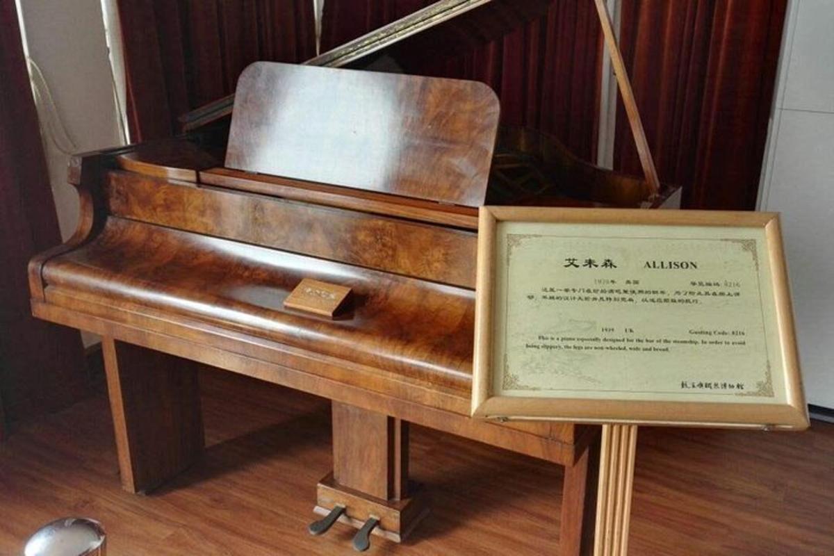 a wooden piano sitting on top of a wooden floor