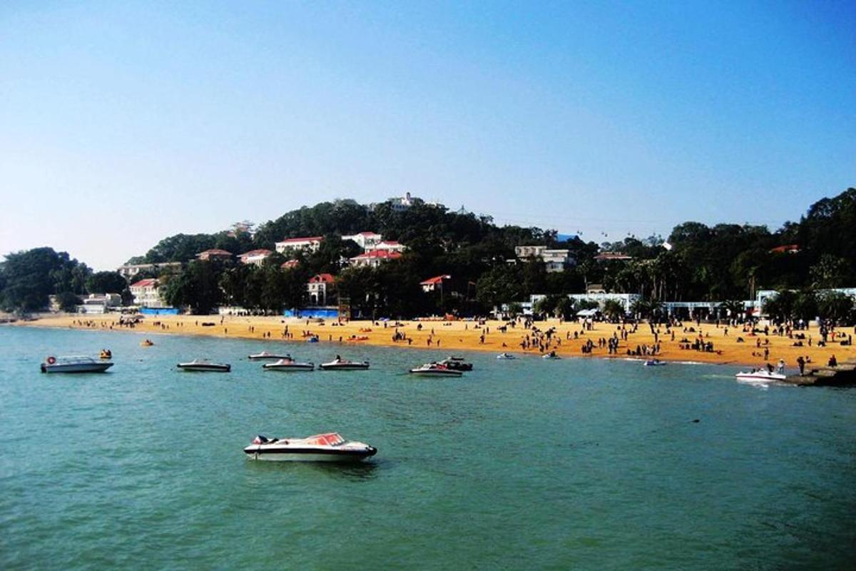 a group of boats in the water at a beach