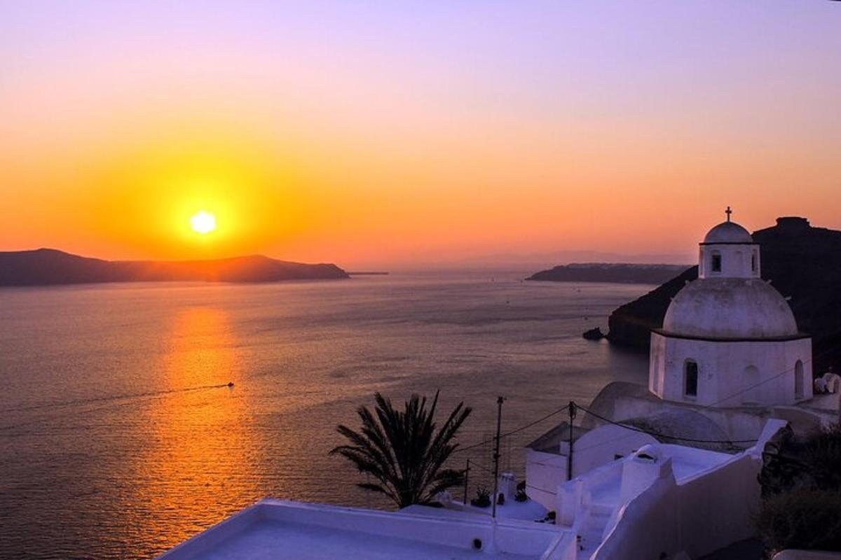 un tramonto sull'acqua con una chiesa e l'oceano