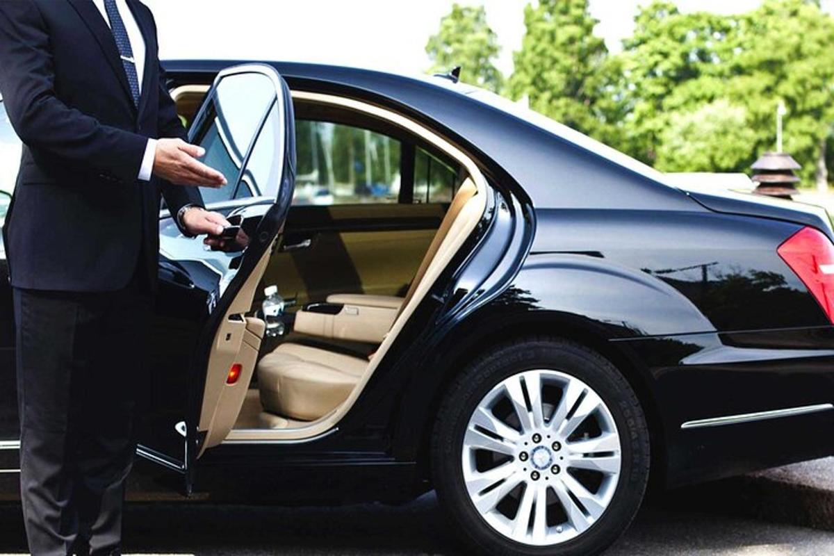 a man is opening the door of a car