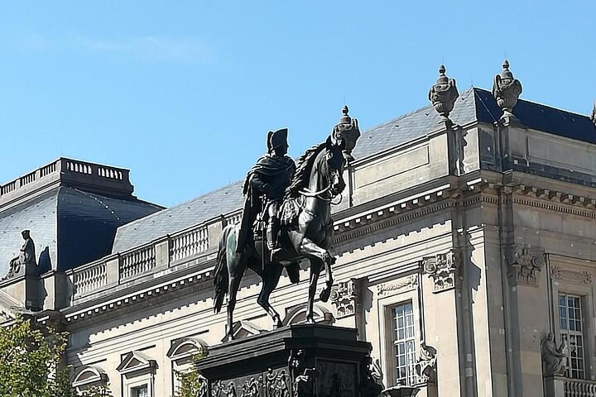 stytta af manni á hesti fyrir framan byggingu