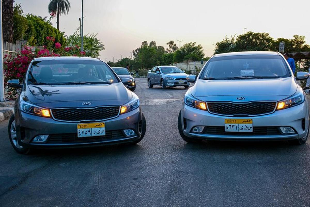 two cars parked next to each other in a parking lot