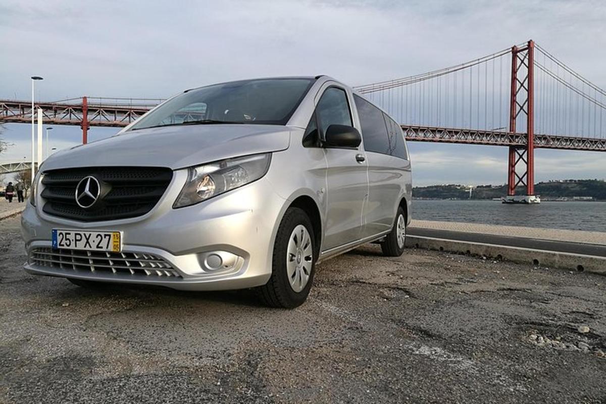 a silver car parked in front of a bridge