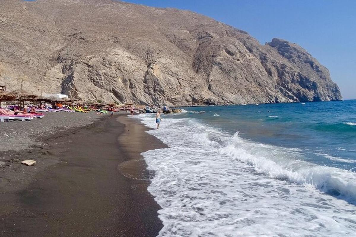 a beach with a bunch of people and the ocean