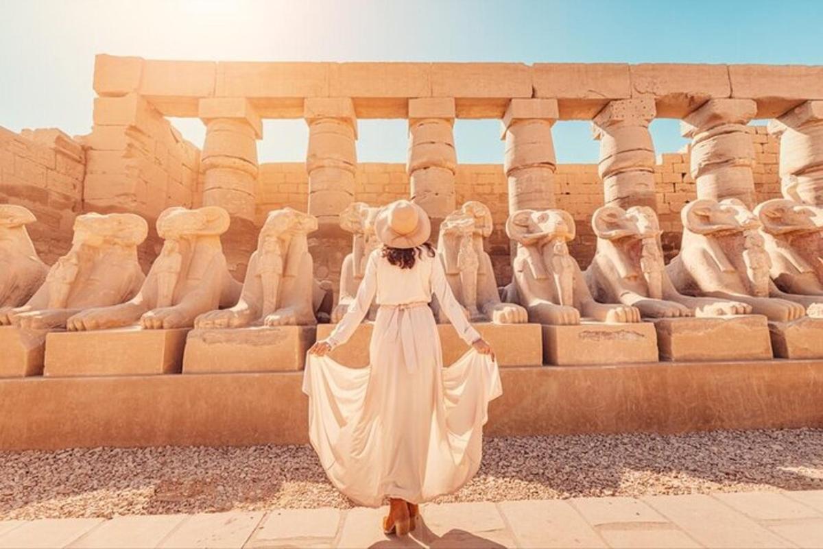a woman in a white dress standing in front of a building