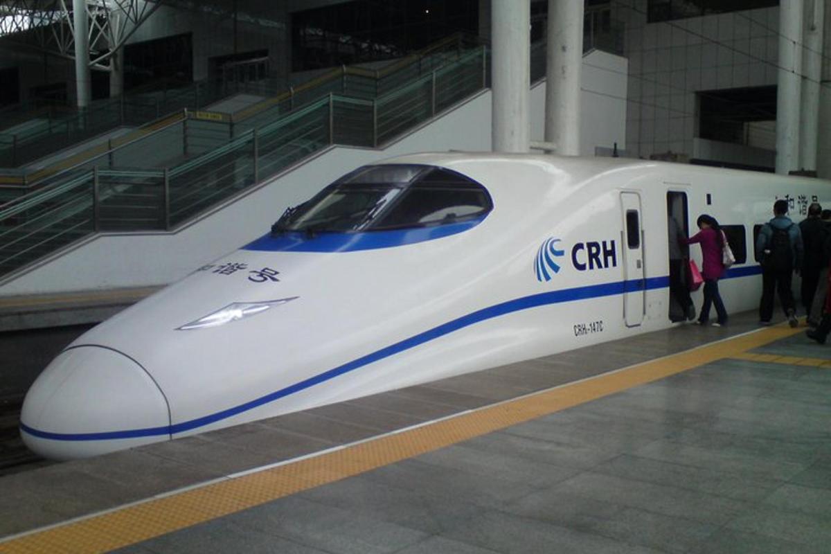 a white and blue train parked at a station