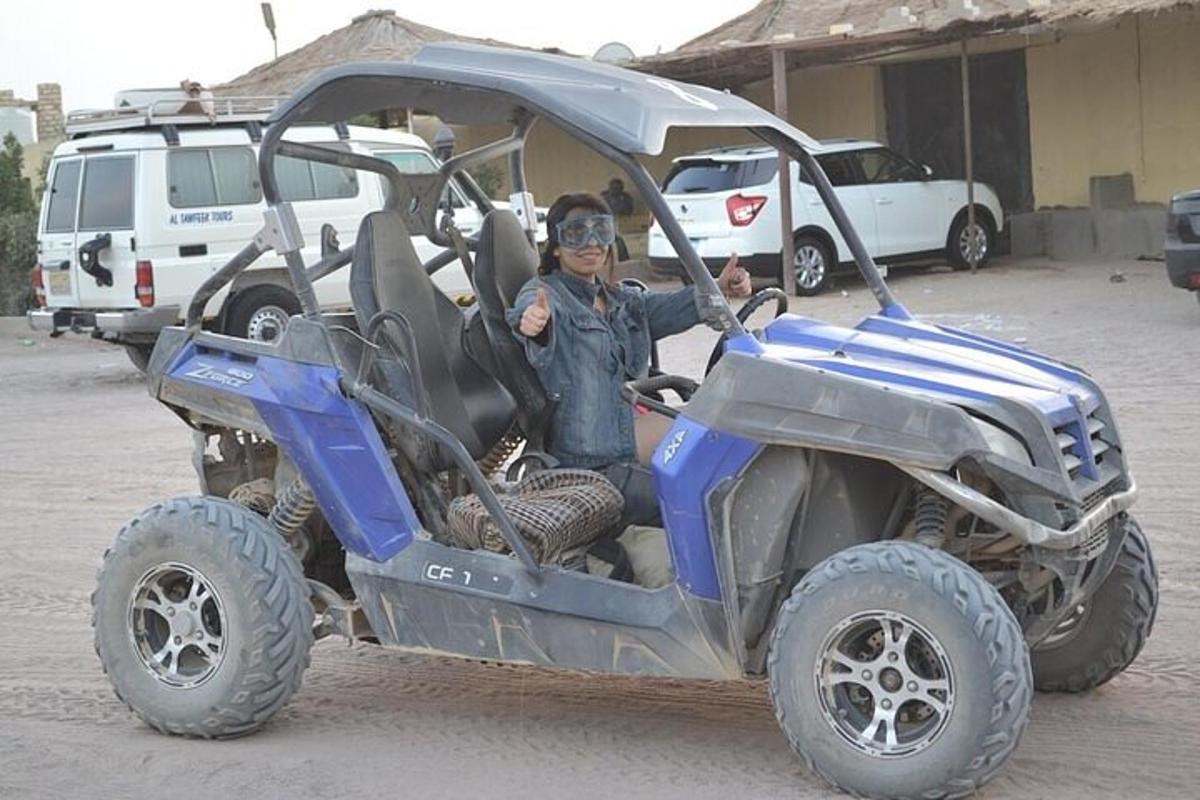a man is sitting in a four wheeled vehicle