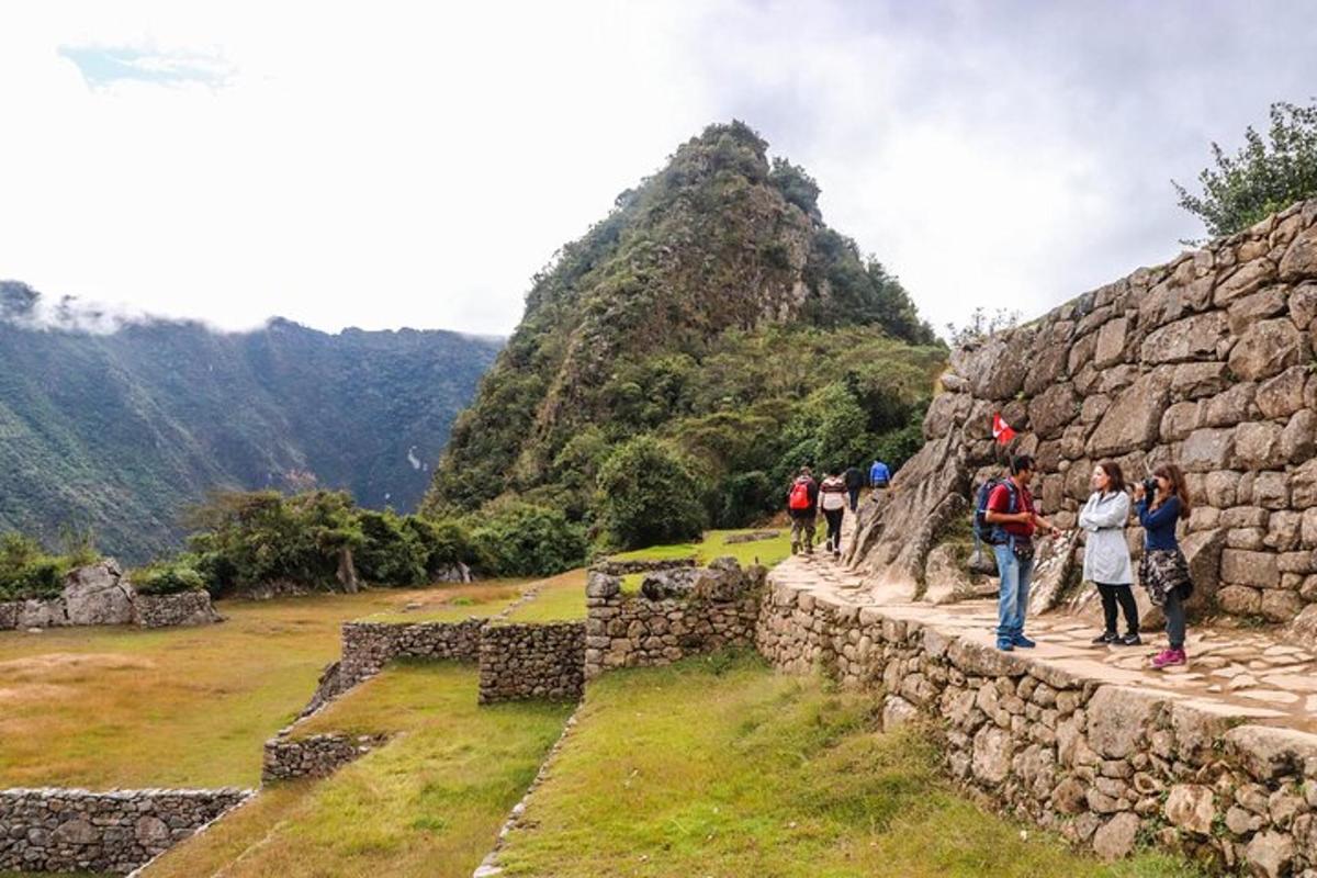 a group of people standing on the ruins of a mountain