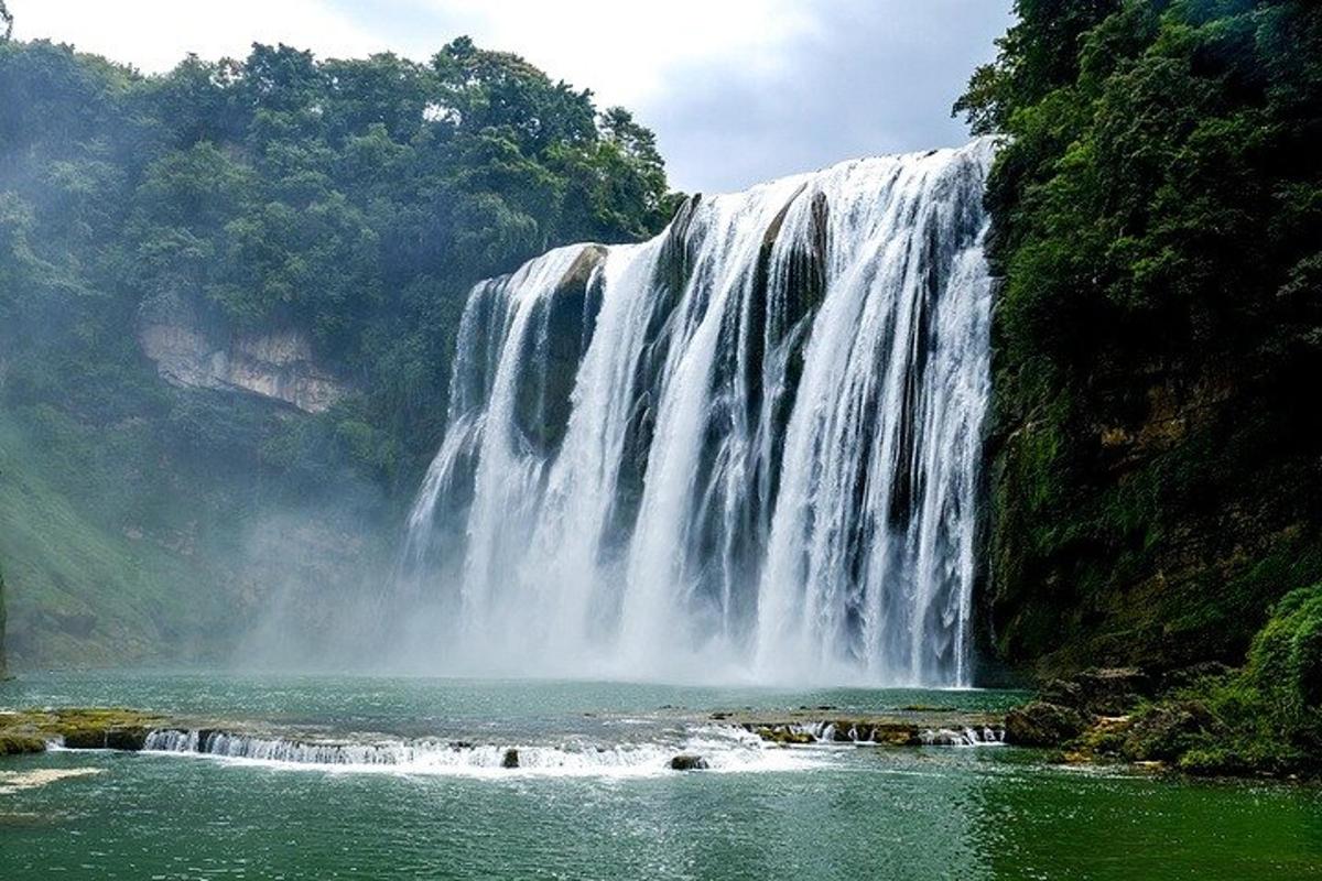 a waterfall in the middle of a body of water