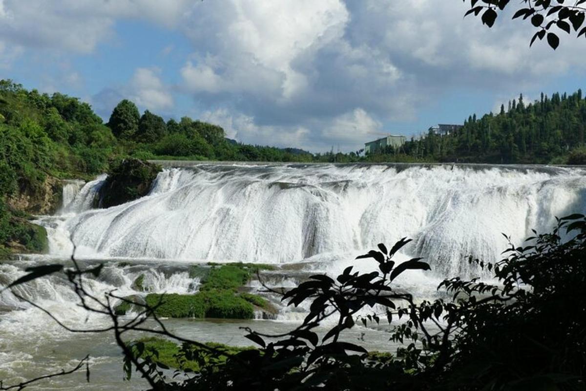 a large waterfall in the middle of a river