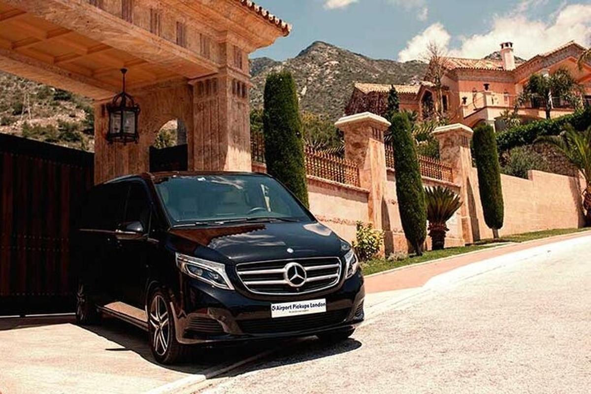 um carro preto estacionado em frente a uma casa