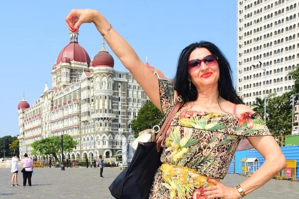 a woman is standing in front of a building