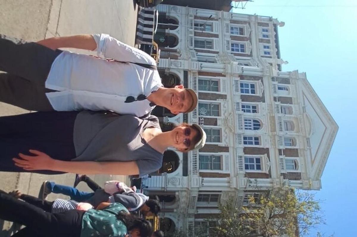 two men are standing in front of a building