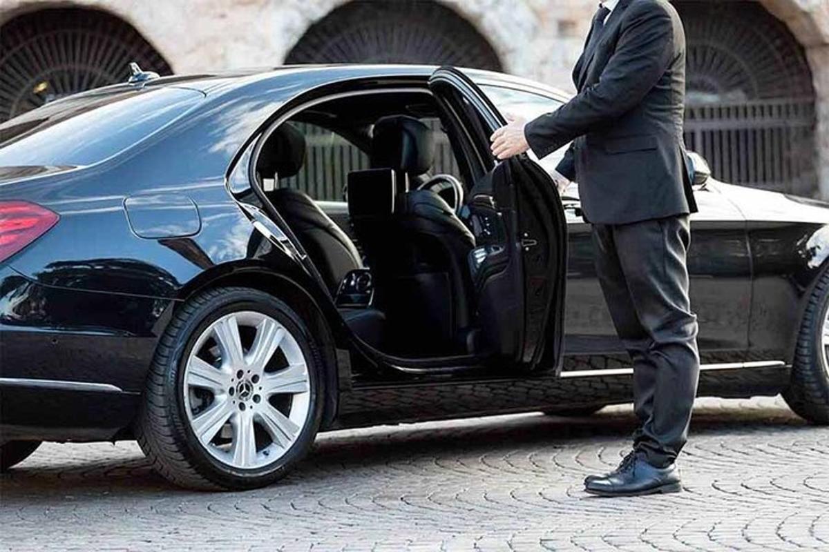 a man in a suit getting into a car