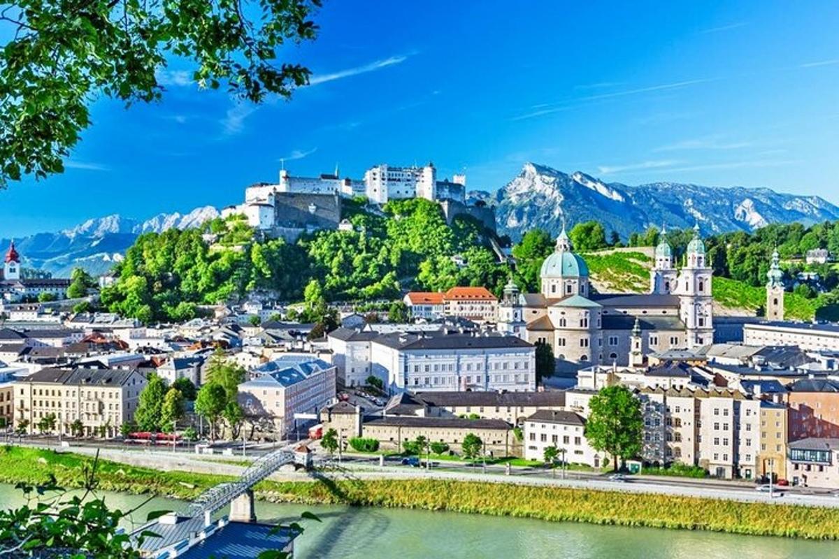 a city with a river and mountains in the background